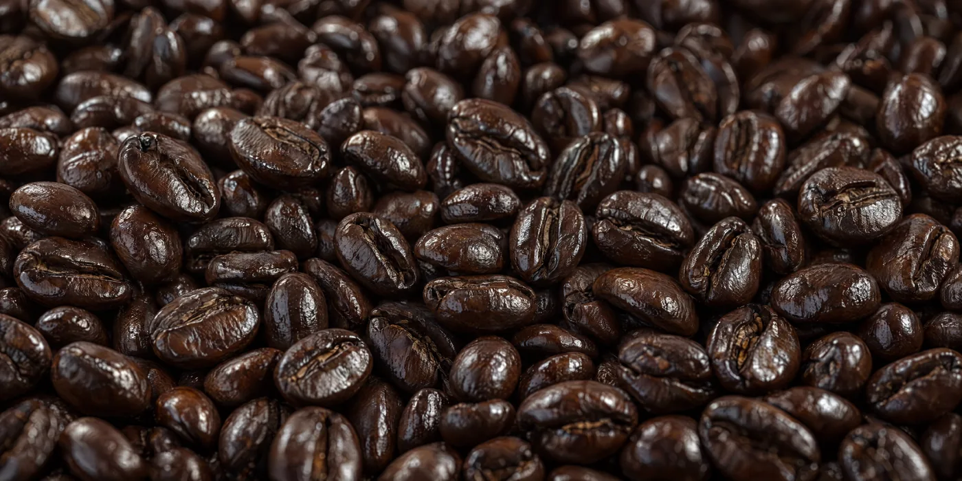 Dark roasted coffee beans with visible surface oils
