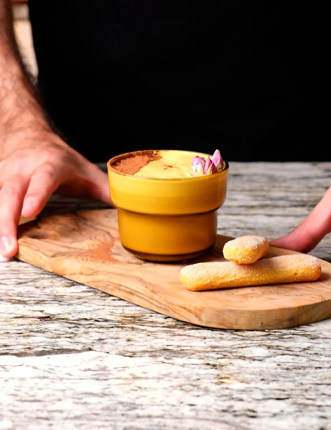 The finished Persian Tiramisu drink served on a wooden board with ladyfingers